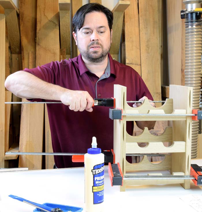 Willie clamping up the frame assembly with a glue bottle in the foreground