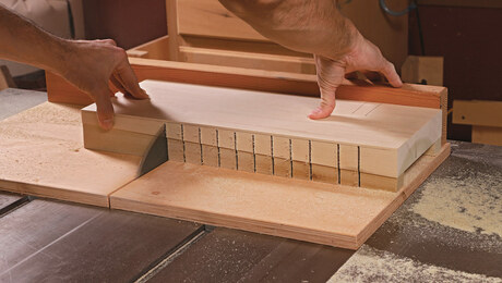 Phillip Morley's hands cutting kerfs in a piece of wood