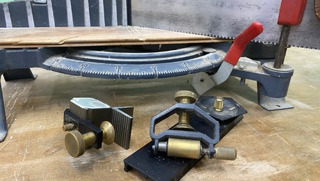 An array of hand tool guide sit on a workbench.